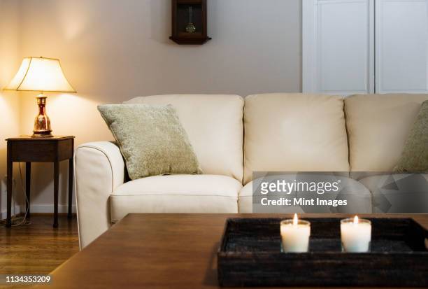 candles lit on tray in living room - mesa baja de salón fotografías e imágenes de stock