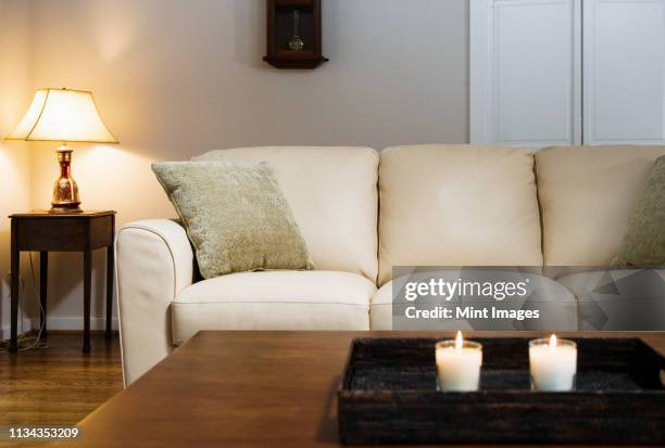 candles lit on tray in living room - coffee table stockfoto's en -beelden