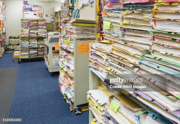 stacks of papers and folders in library - health records stock pictures, royalty-free photos & images