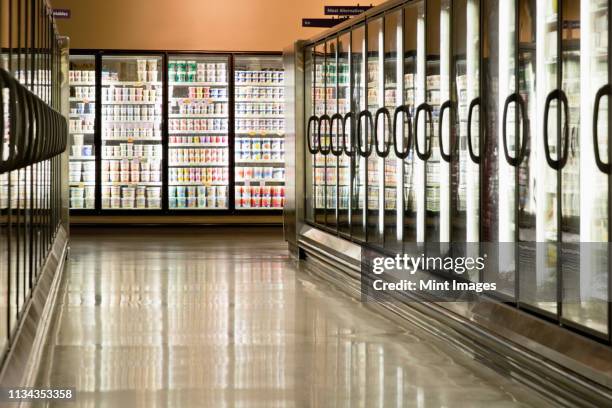 freezer cases in supermarket - supermarket fridge stock pictures, royalty-free photos & images