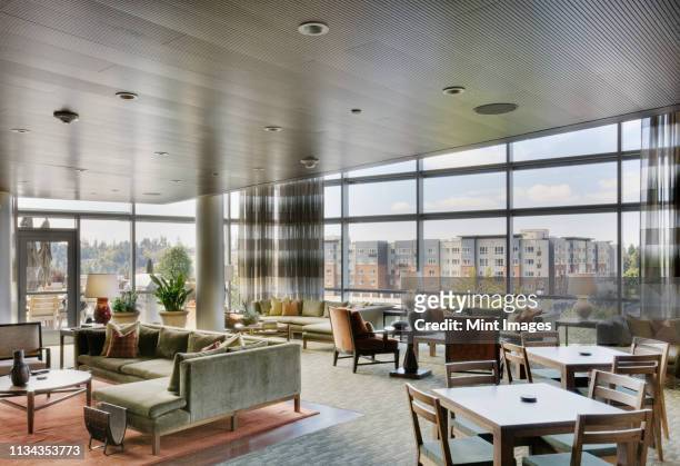 clubhouse in highrise apartment building - building lobby stock pictures, royalty-free photos & images