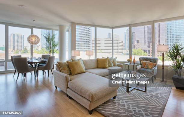 living room and dining room in luxury highrise apartment - apartment cross section stock pictures, royalty-free photos & images