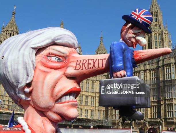 Giant effigy of Prime Minister Theresa May, with the British economy stuck to her long nose, is seen outside the Houses of Parliament during an anti...