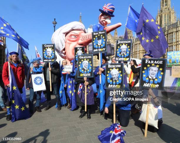 Giant effigy of Prime Minister Theresa May, with the British economy stuck to her long nose, seen among demonstrators outside the Houses of...