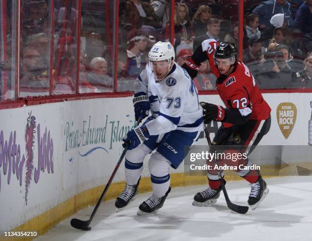 Adam Erne of the Tampa Bay Lightning stickhandles the puck away from Thomas Chabot of the Ottawa Senators at Canadian Tire Centre on April 1, 2019 in...