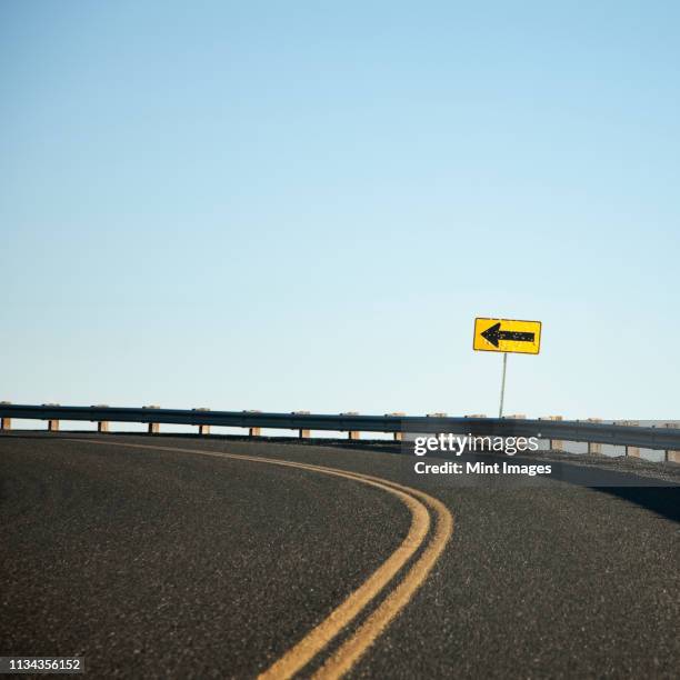 road curving left - road signs & markings stock pictures, royalty-free photos & images