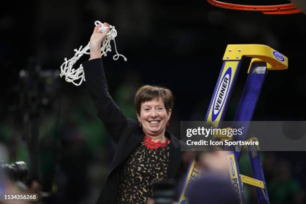 Notre Dame Fighting Irish head coach Muffet McGraw celebrates with fans and teammates after cutting down the net during the net cutting ceremony...