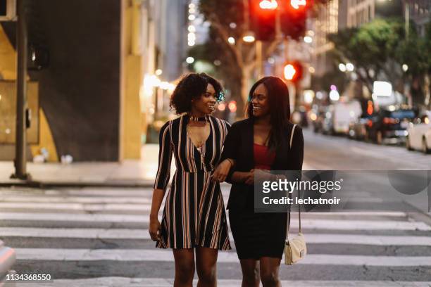 Two young female friends walking in downtown Los Angeles