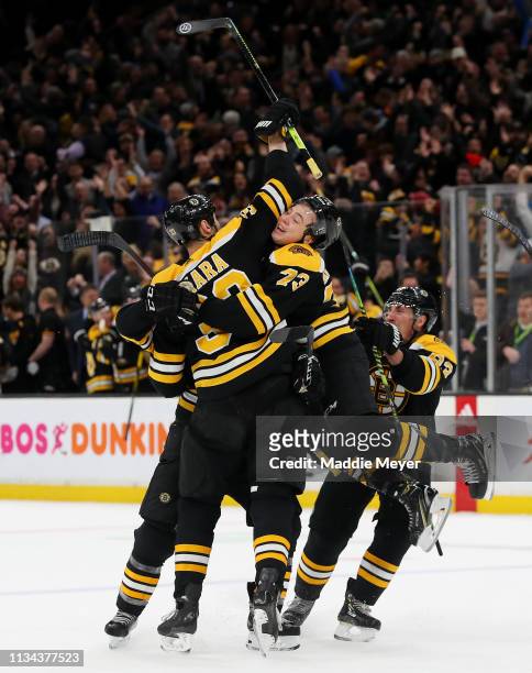 Zdeno Chara, Charlie McAvoy, Brad Marchand celebrate with Patrice Bergeron of the Boston Bruins after he scored the game winning goal against the...