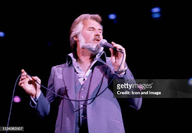 American, country singer Kenny Rogers sings on stage during a concert on November 8, 1981 at the Crisler Arena in Ann Arbor, Michigan.