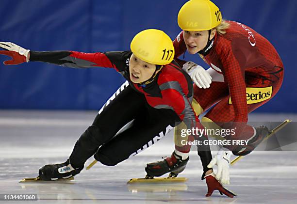 Amelie Goulet-Nadon of Canada pushes Wei Wang of China in the final lap in the women's 3000m relay finals at the ISU World CUP Short Track Speed...