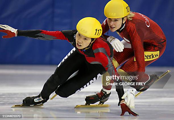 Amelie Goulet-Nadon of Canada pushes Wei Wang of China in the final lap in the women's 3000m relay finals at the ISU World CUP Short Track Speed...