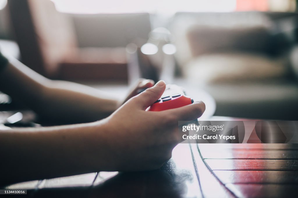 Close up of  boy holding game controller