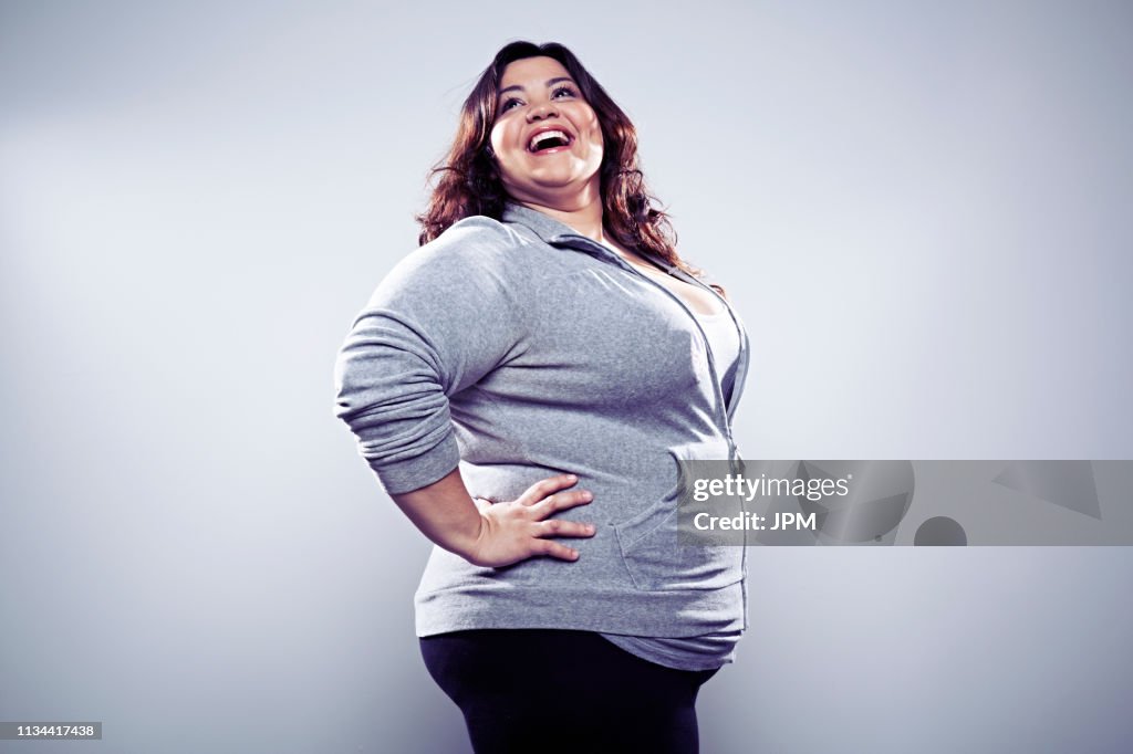 Mid adult woman wearing grey top, hands on hips