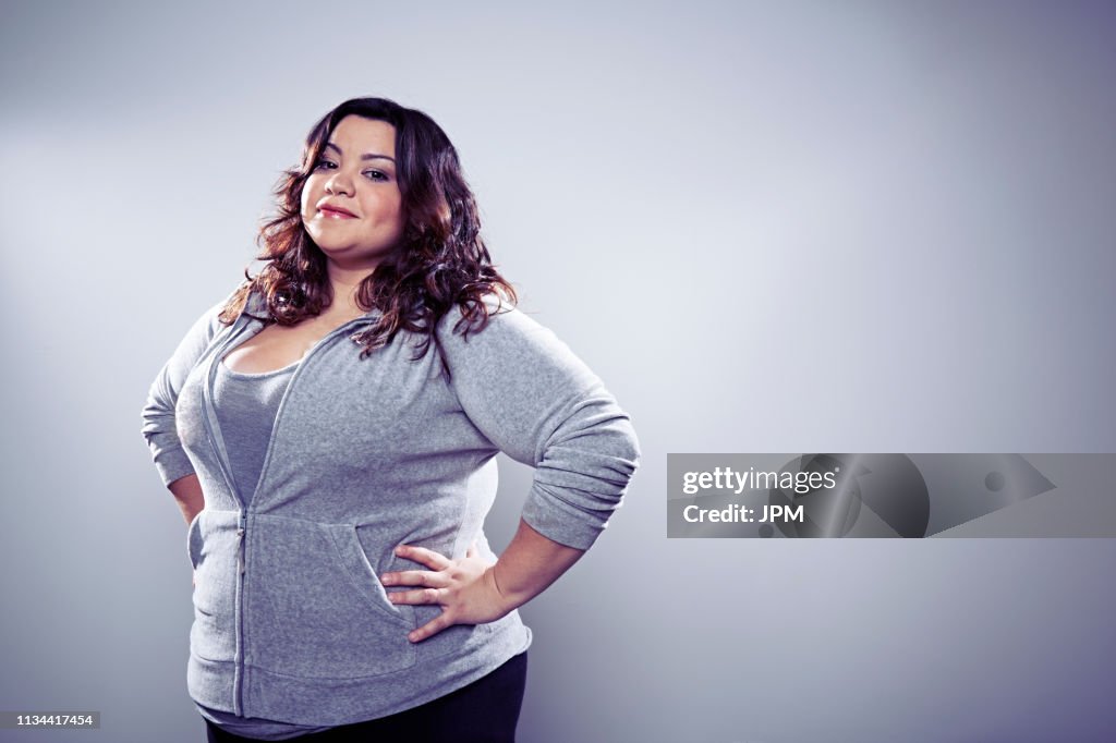 Mid adult woman wearing grey top, hands on hips