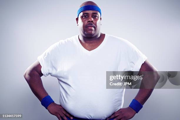 mature man wearing white t shirt, hands on hips - sweat band stock pictures, royalty-free photos & images