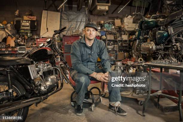 mechanic in his garage converting gas powered motorcycles to bio-diesel - motorcycle mechanic stock pictures, royalty-free photos & images