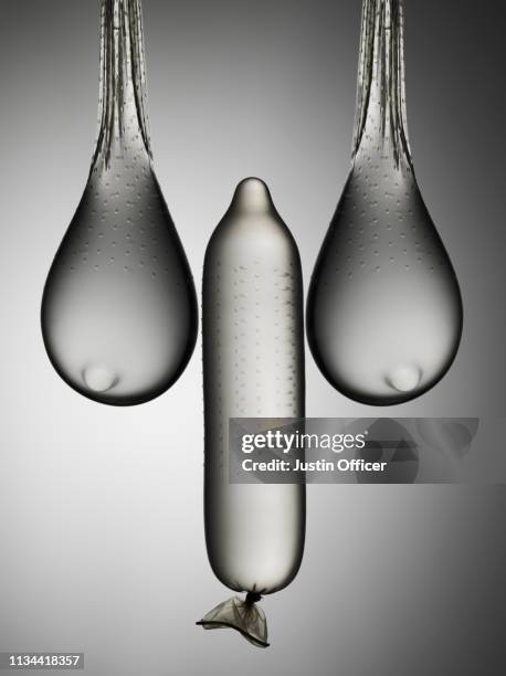 still life of condoms suggesting male and female anatomy - pene foto e immagini stock