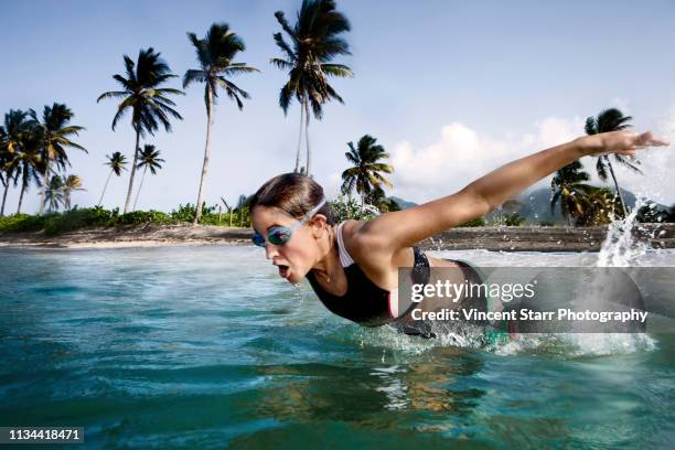 mid adult triathlete swimming in sea - saint kitts and nevis stock pictures, royalty-free photos & images