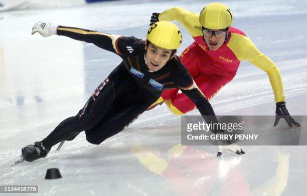Satoru Teroa of Japan takes the lead from Yulong An of China 11 March 2000, to win men's 500m quarter final during the World Short Track Speed...