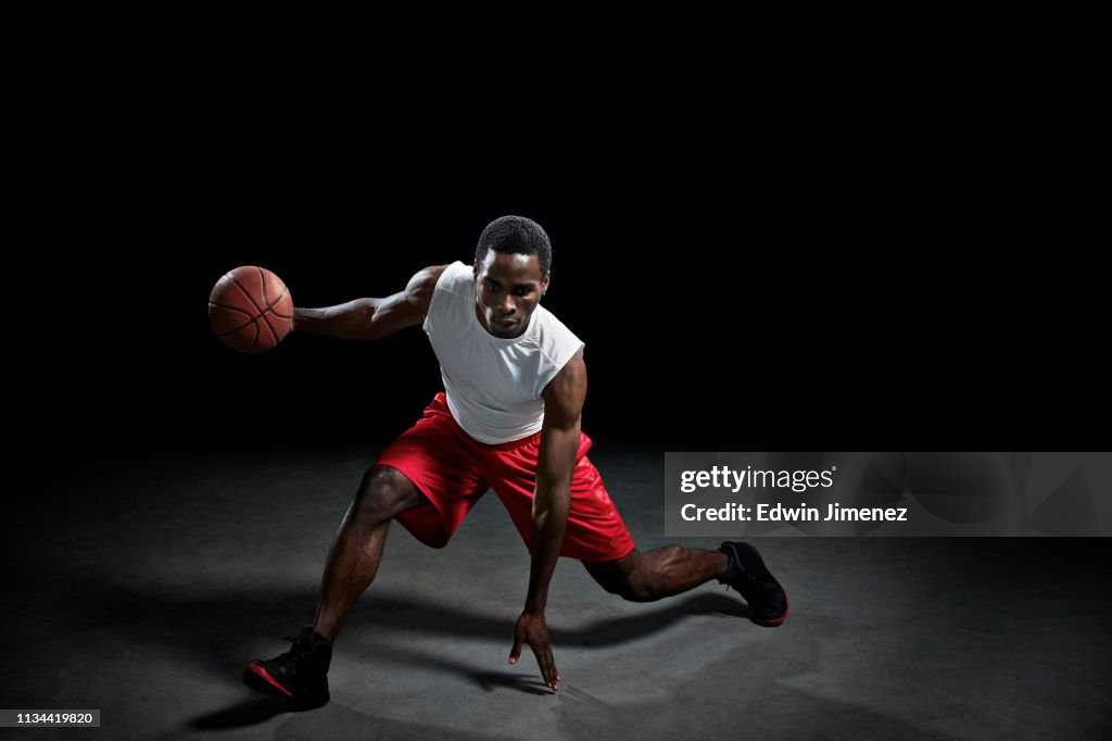 Studio shot of basketball player with ball