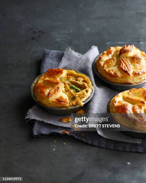 still life of three chicken pies made with puff pastry - savoury pie stock pictures, royalty-free photos & images