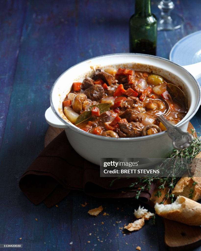 Beef daube in casserole dish with baguette