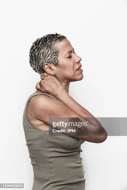 senior woman with neck pain - portrait white background male foto e immagini stock