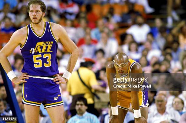 Kareem Abdul-Jabbar of the Los Angeles Lakers rests next to Mark Eaton of the Utah Jazz during an NBA game at the Great Western Forum in Los Angeles,...