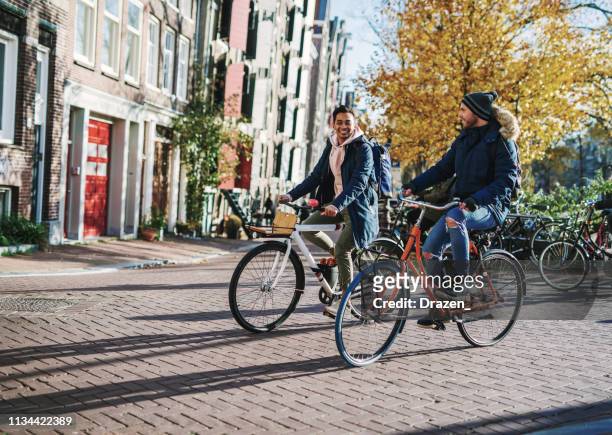 lgbt couple on city break - diverse millennial gay guys are in relationship and spending time on city break - netherlands stock pictures, royalty-free photos & images
