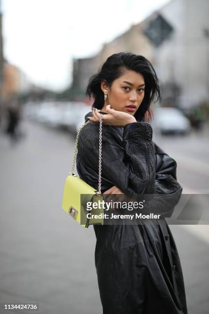Anuthida Ploypetch wearing a Furla bag and vintage leather coat on March 07, 2019 in Berlin, Germany.