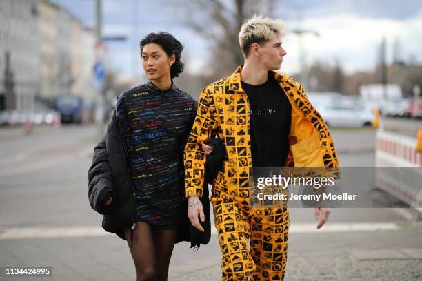 Anuthida Ploypetch and Richy Koll wearing a Balenciaga shirt, Buffalo shoes and Obey jacket and pants on March 07, 2019 in Berlin, Germany.