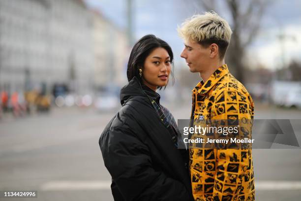 Anuthida Ploypetch and Richy Koll wearing a Balenciaga shirt, Buffalo shoes and Obey jacket and pants on March 07, 2019 in Berlin, Germany.