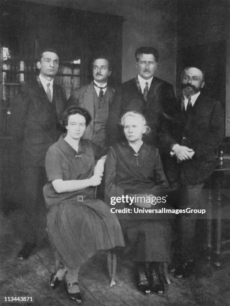 Marie Curie Polish-born French physicist, with her daughter Irene Joliot-Curie with members of the Institute of Radium, Paris. On the right is their...