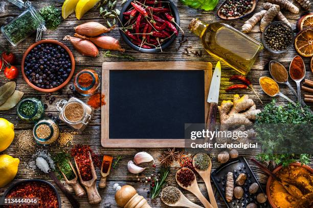 specerijen en kruiden frame schot van bovenaf op rustieke houten tafel - chalkboard background stockfoto's en -beelden