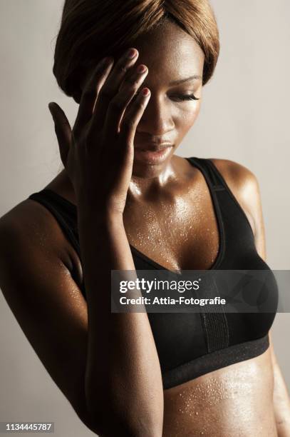 studio shot of woman with hand on face - woman shielding face stock pictures, royalty-free photos & images