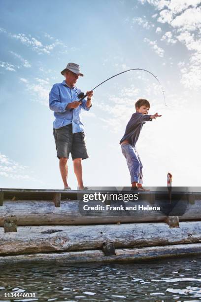 grandfather and grandson fishing, utvalnas, sweden - mole animal stock-fotos und bilder