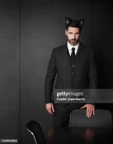 businessman wearing fancy dress ears - cat costume stock pictures, royalty-free photos & images