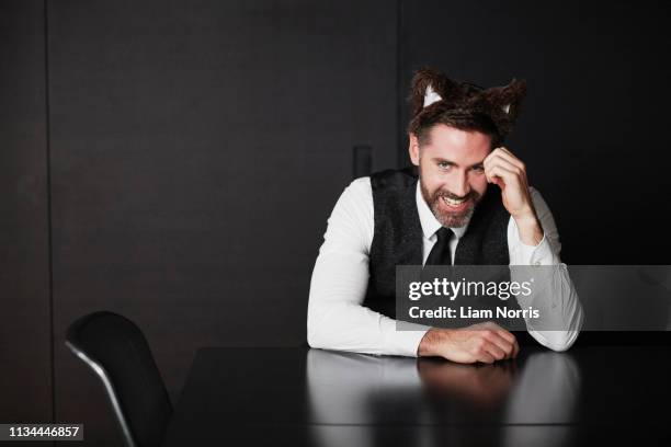 businessman wearing animal ears - leaning on elbows stock pictures, royalty-free photos & images