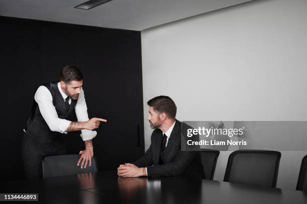 manager pointing at employee, multiple image - schizophrenia stock-fotos und bilder