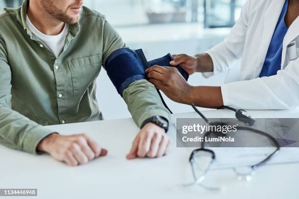 let's take your blood pressure reading - hypertensive stock pictures, royalty-free photos & images