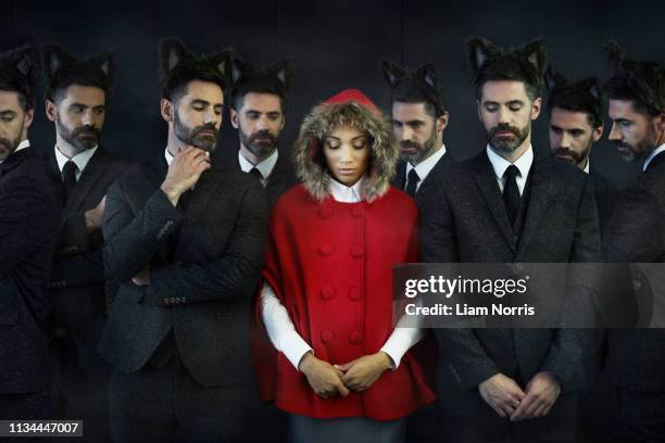 woman dressed as little red riding hood with businessmen, multiple image - surrounding ストックフォトと画像