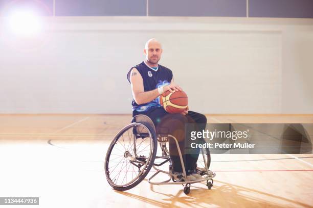 wheelchair basketball player holding ball - british basketball stock pictures, royalty-free photos & images
