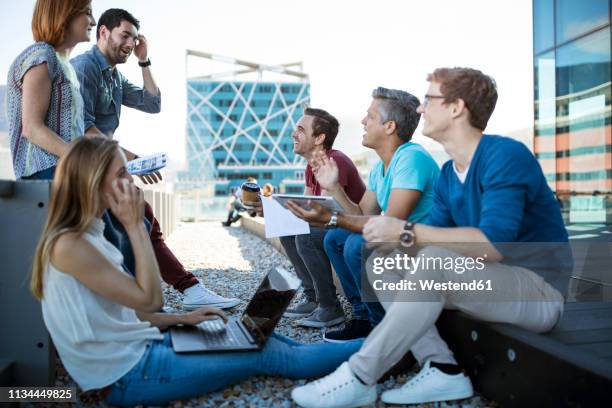 business people having a casual meeting on a rooftop terrace - rooftop garden stock pictures, royalty-free photos & images