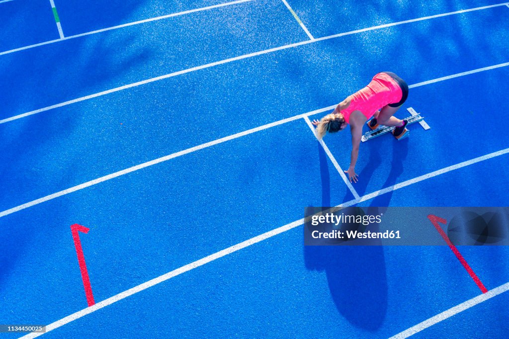 Top view of female runner in starting position