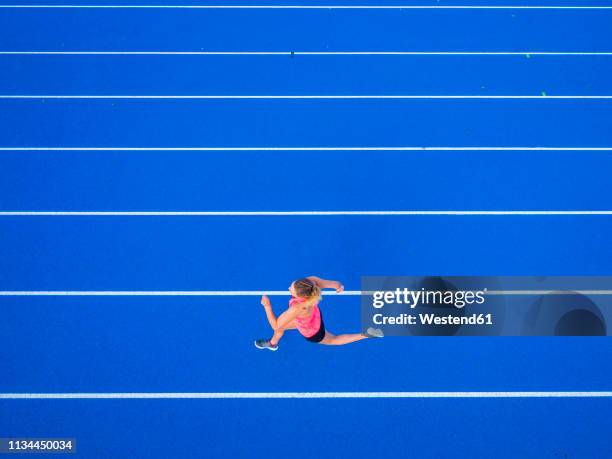 top view of female runner on tartan track - single track stock pictures, royalty-free photos & images