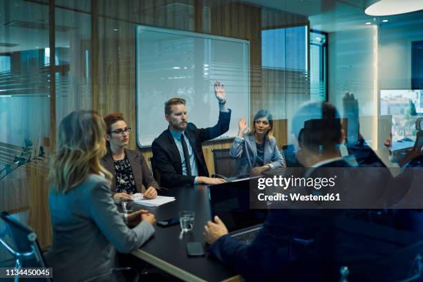 group of business people voting during meeting - people voting stock pictures, royalty-free photos & images