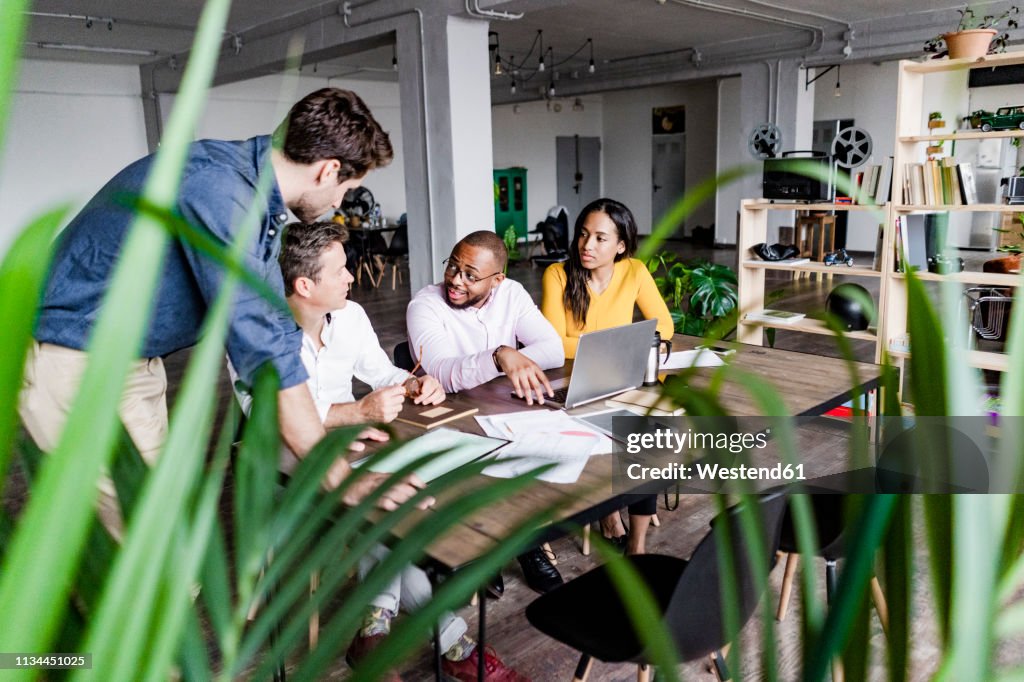 Confident business team having a meeting in loft office