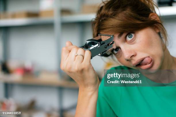 funny woman in office stamping her forehead - burocrazia foto e immagini stock