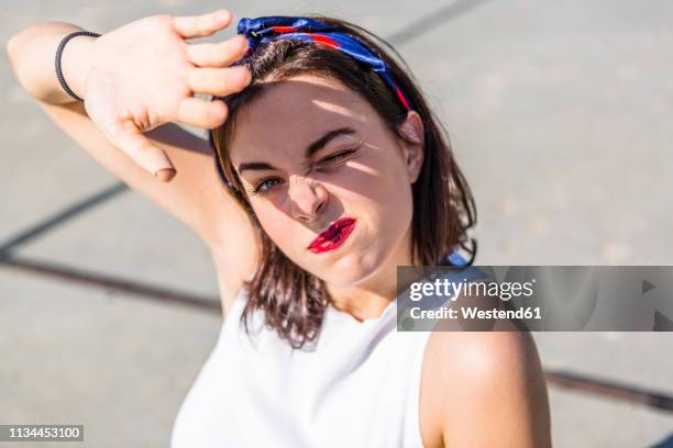 portrait of beautiful young woman shielding her eyes - bright sunlight stock pictures, royalty-free photos & images